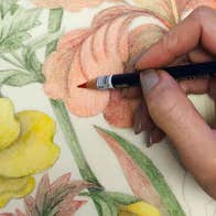 Drop-in Drawing with Roxana Manouchehri, close up view of a hand holding pencil colouring hand drawn flowers in pale pink, yellow and green stems and leaves.