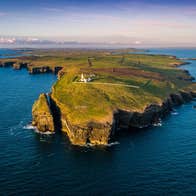 An aerial view of Loop Head and the lighthouse from the ocean