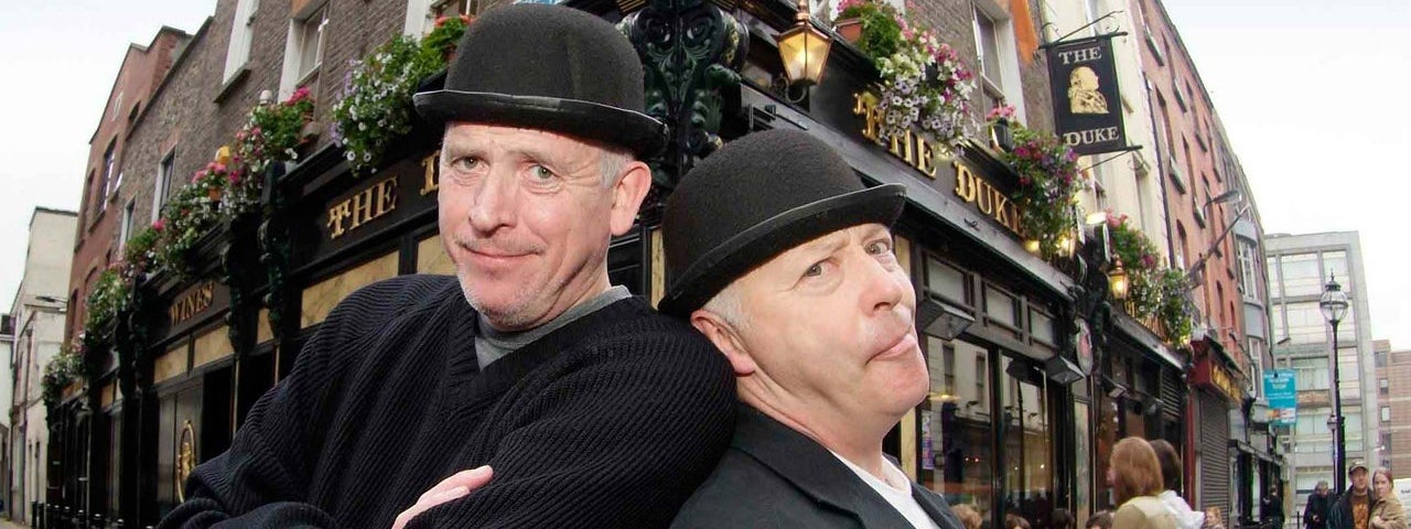 Two people in costume posing outside a pub