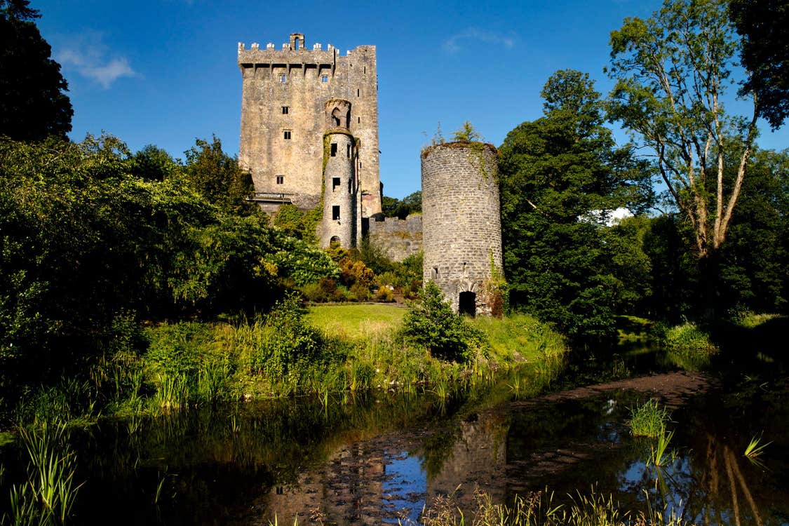 A river beside Blarney Castle in Cork on a sunny day.