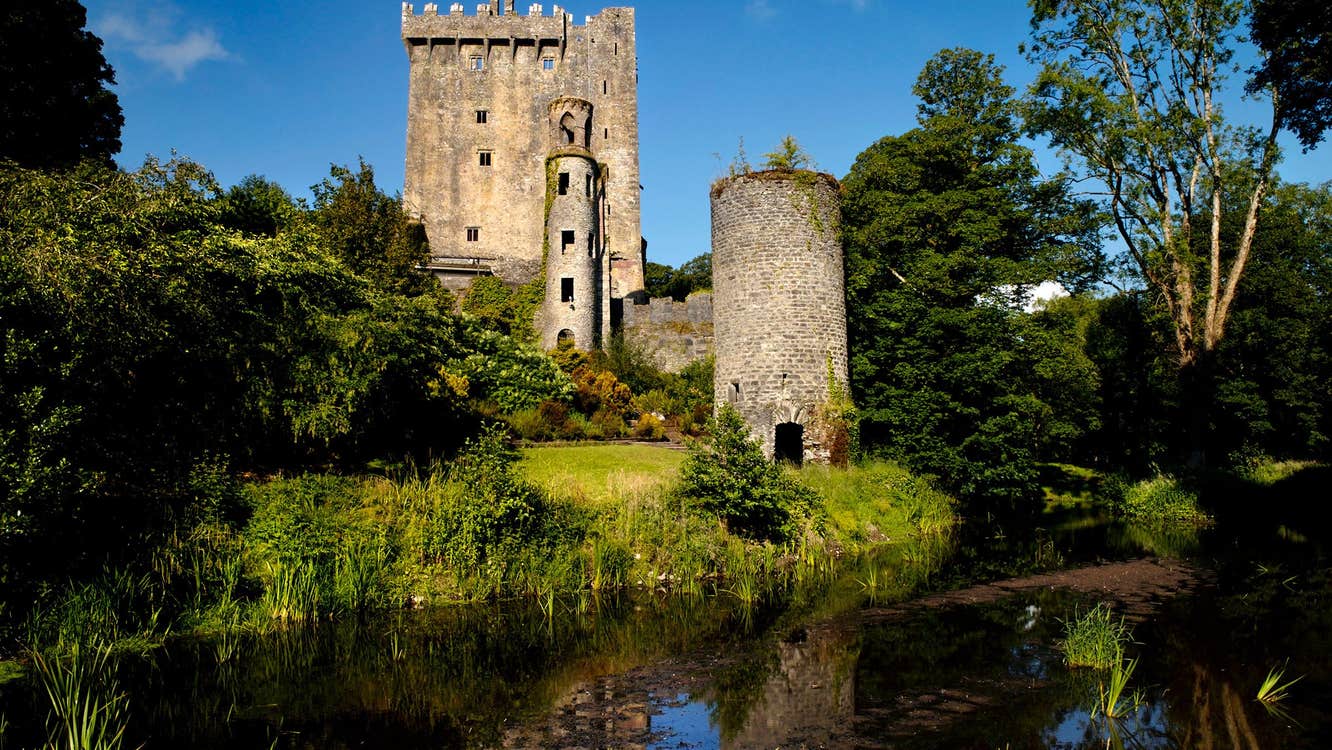 A river beside Blarney Castle in Cork on a sunny day.