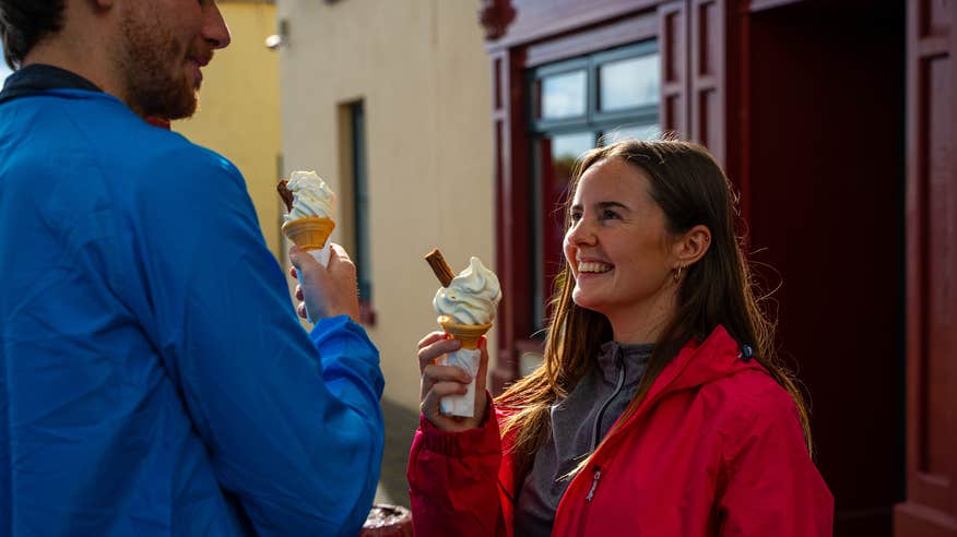Couple enjoying a 99 outside a pub.