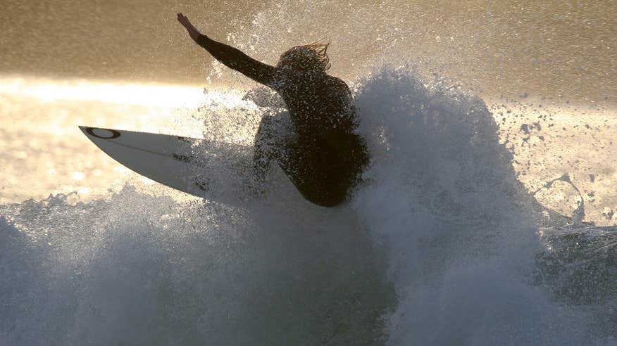 Surfing a wave at Enniscrone Co. Sligo along the Wild Atlantic Way on a white surfboard