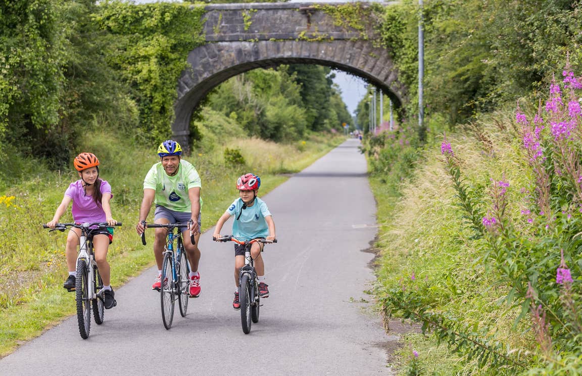 A family cycling the Old Rail Trail Greenway in Westmeath