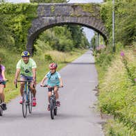 A family cycling the Old Rail Trail Greenway in Westmeath