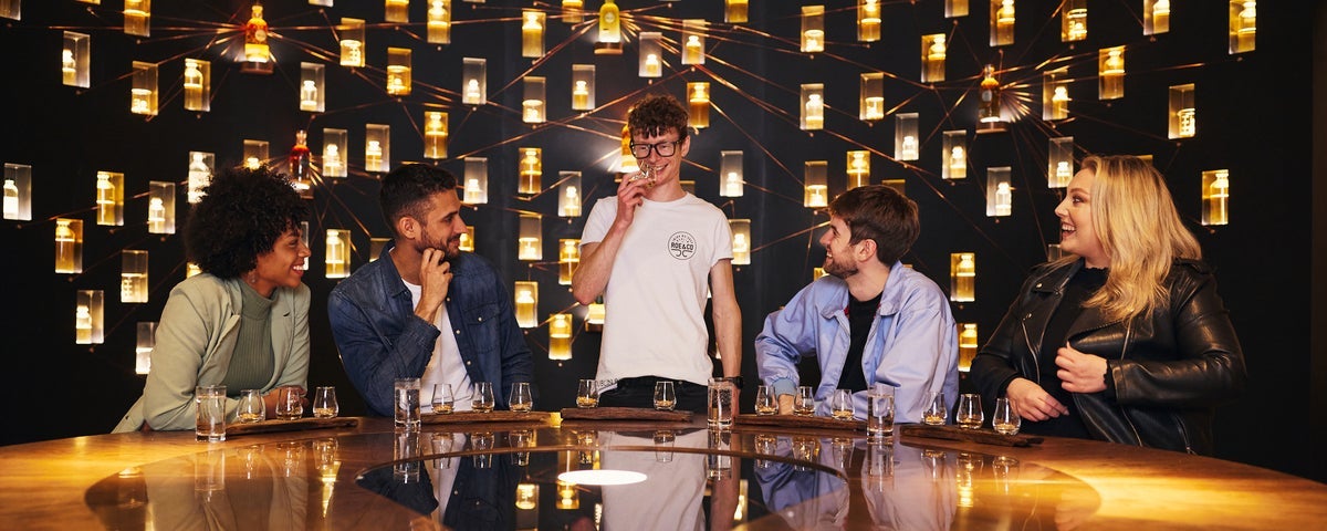 A group of people sampling whiskey
