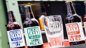Bottles of beer beside a glass outside Treaty City Brewery in Limerick city.