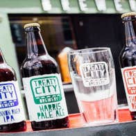 Bottles of beer beside a glass outside Treaty City Brewery in Limerick city.