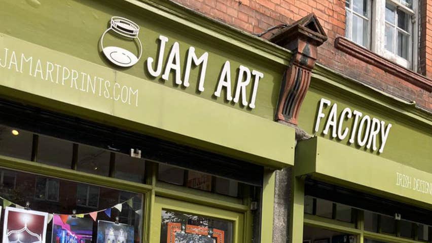 Green shopfront and sign over door saying Jam Art Factory
