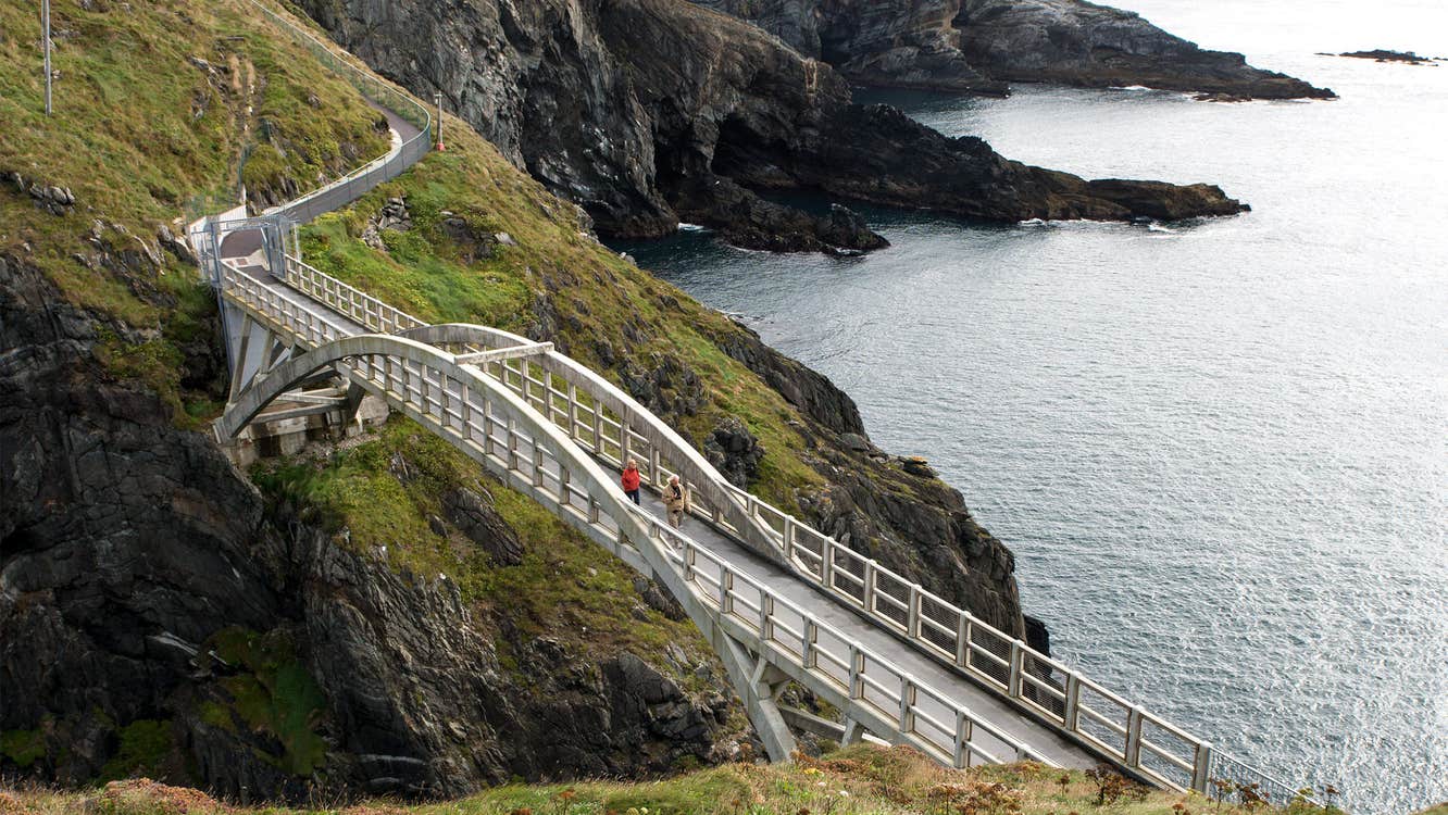 People walking across the bridge at Mizen Head in County Cork.