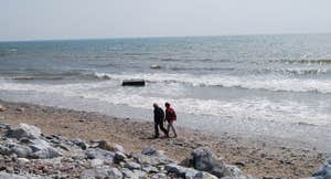 Couple walking on Garryvoe Beach