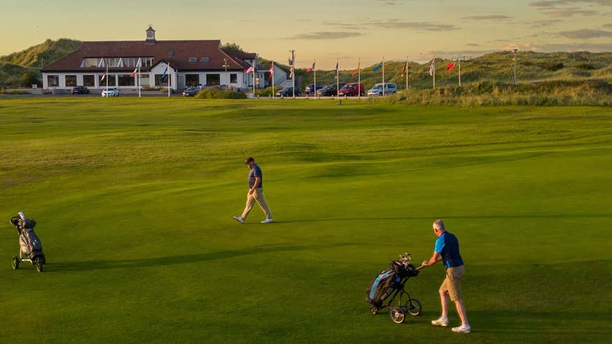 Golfers playing Enniscrone Golf Club in County Sligo