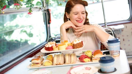 A lady sitting at a table set with an afternoon tea