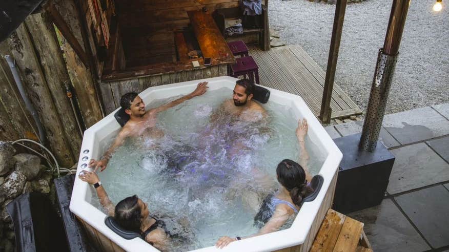 Four people in a hot tub at Mayo Glamping in County Mayo