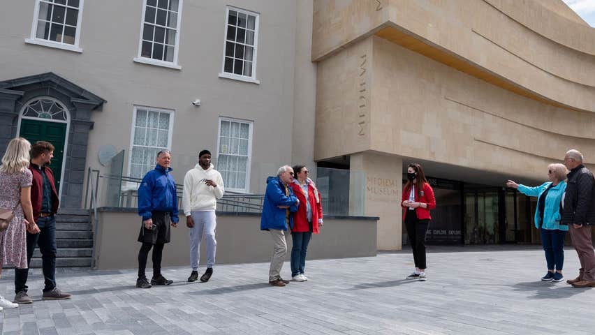 A group with a tour guide outside Waterford Treasures Museums