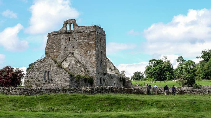 A group of people exploring the ruins at Jerpoint Park, Kilkenny