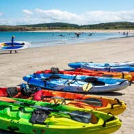 Colourful kayaks on the sand at Marble Hill Beach, Co Donegal