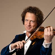 Violinist Vladimir Jablokov, a smiling man playing a violin