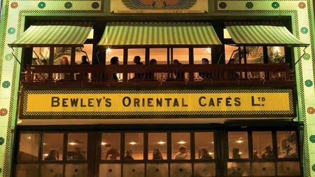 Exterior of a three storey city building with a business sign