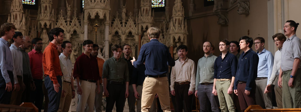 A group of men singing in a churc