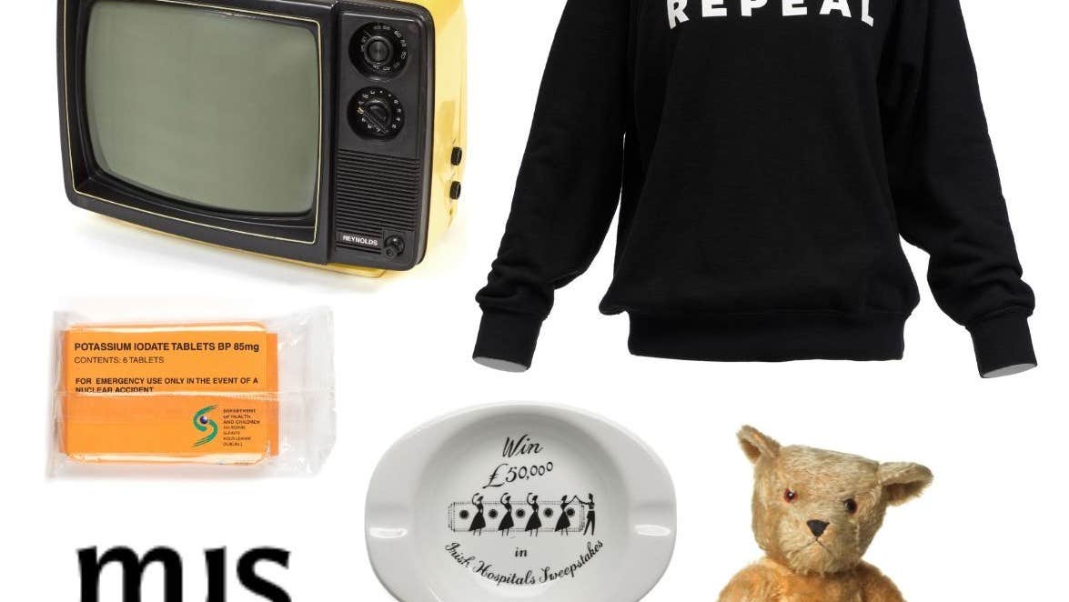 A group of random items against a white background including a teddy bear, a ashtray and an old portable TV