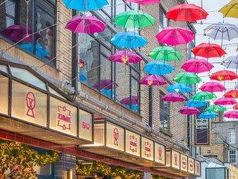 Zozimus Bar exterior view showing colourful umbrellas overhead