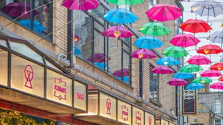 Zozimus Bar exterior view showing colourful umbrellas overhead