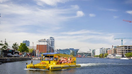 A boat with passengers on a river tour in a city