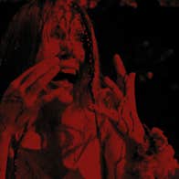 A dark figure in red is screaming with hands held up to their face.