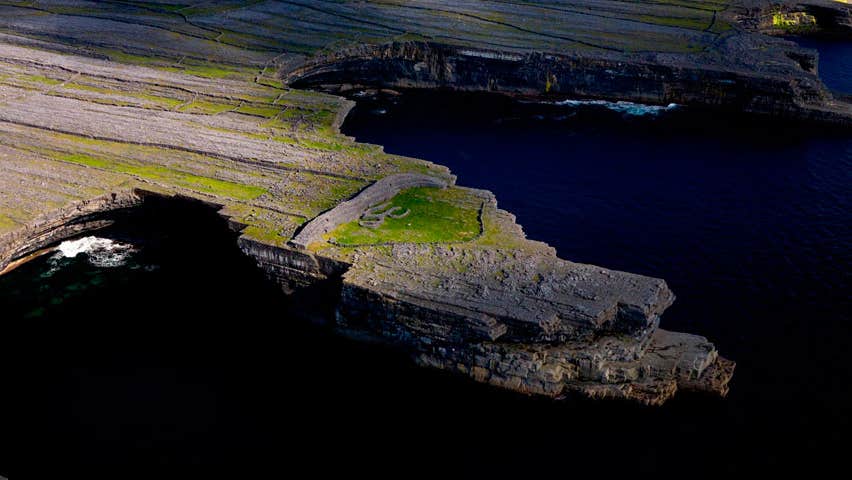 Aerial view of Dun Ducathair Fort on cliff edge of Inishmore Aran Islands