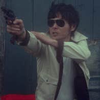 A man is pointing a pistol.