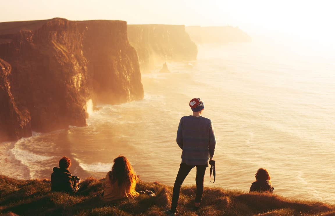 Four people admiring the views from the Cliffs of Moher