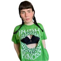 A woman wearing a green Irish theme T-shirt with front missing to show black bra underneath