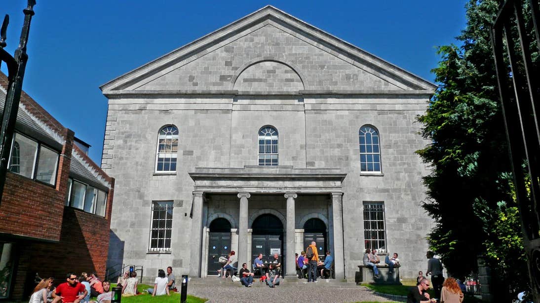 Blue skies and people sitting outside Triskel Christ Church, Co. Cork
