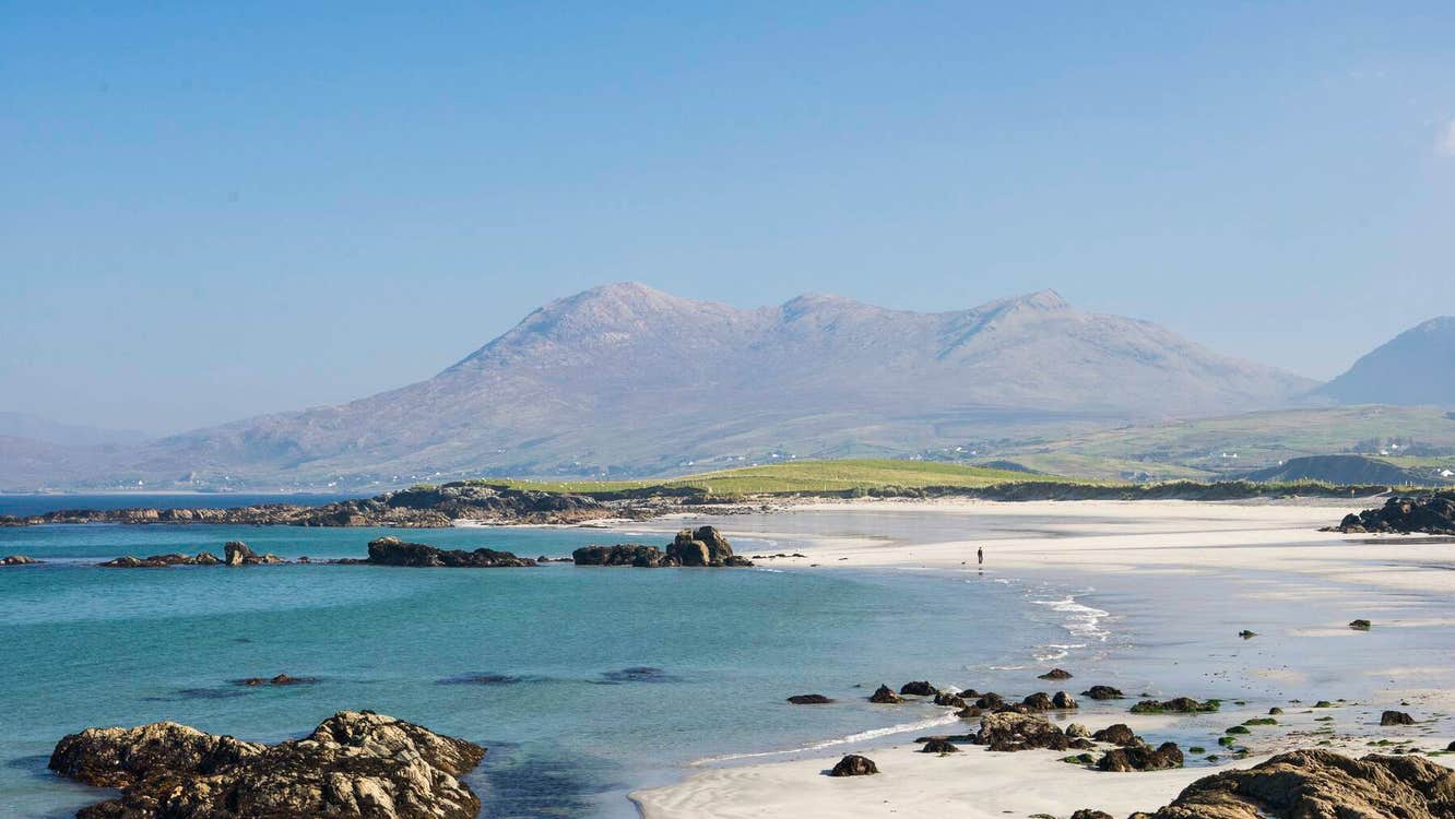 Renvyle Beach with sea and blue sky with mountain