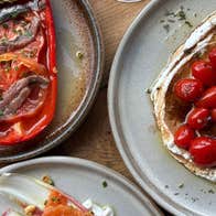 A roasted red pepper dish and a cherry tomato plate