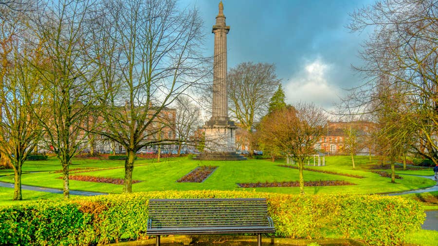 A bench with a Doric column in the background