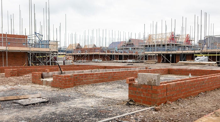 A building site on a housing development with scaffolding and rooftops