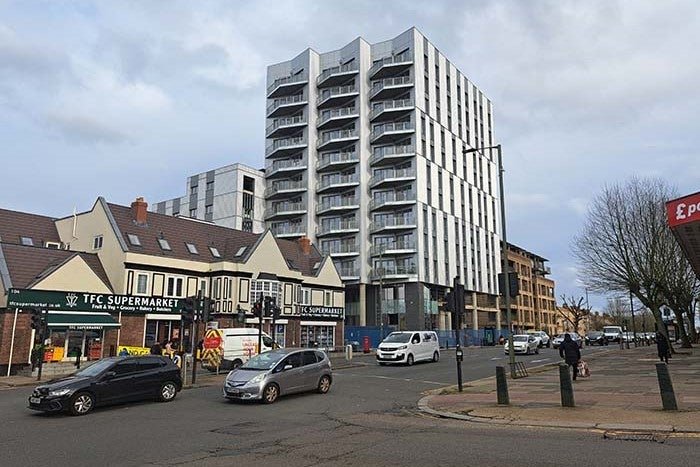 Photo of road with the Burnt Oak development on the left hand side