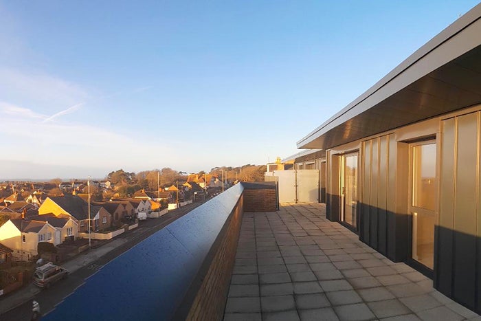 View from the balcony of a new build house, overlooking a street of terraced houses